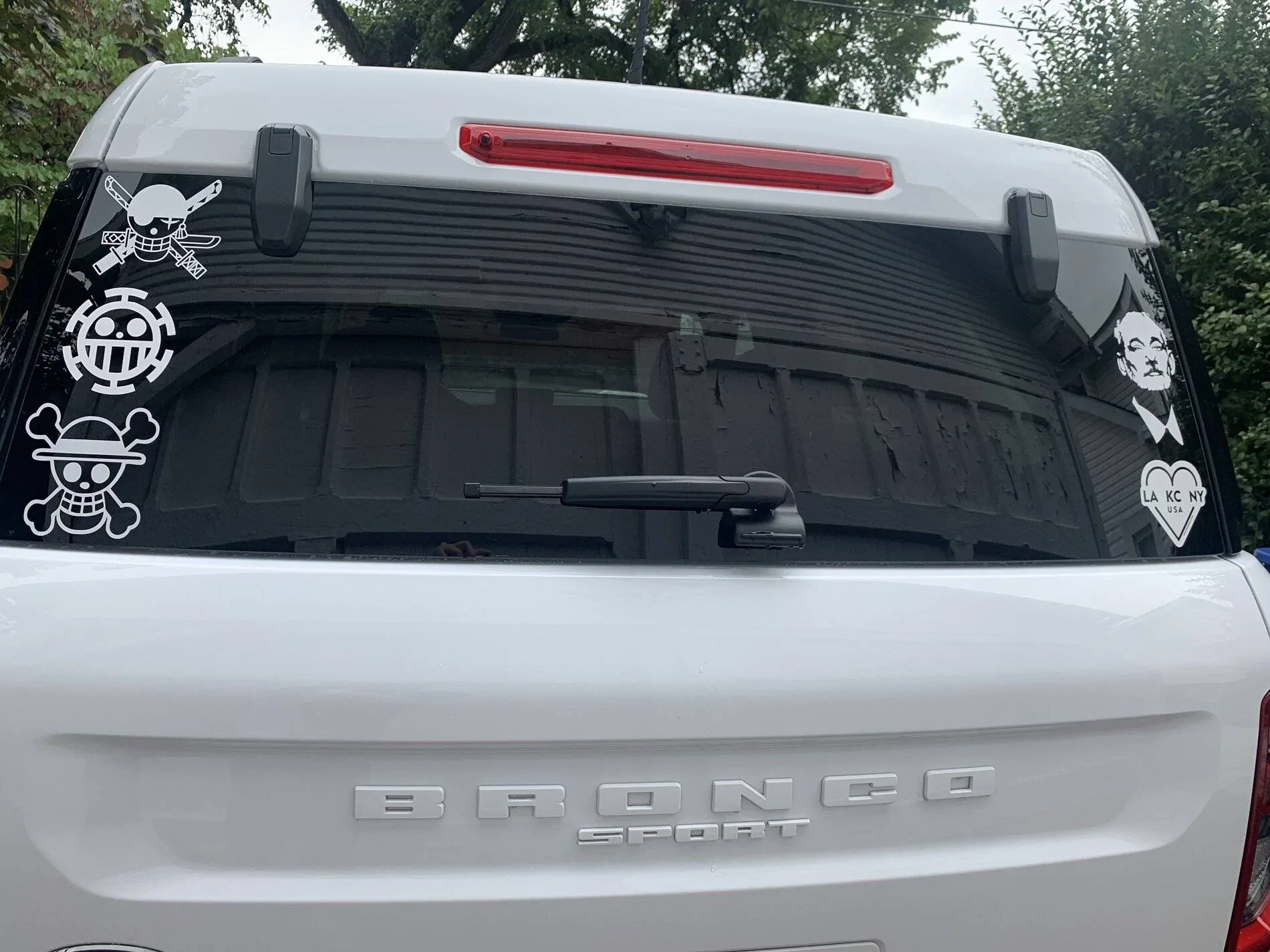 Ford Bronco Sport White Big Bend model has almost invisible BRONCO SPORT logo on rear hatch door.  A can of Matte Black Plasti Dip really dresses it up nicely. IMG_8201