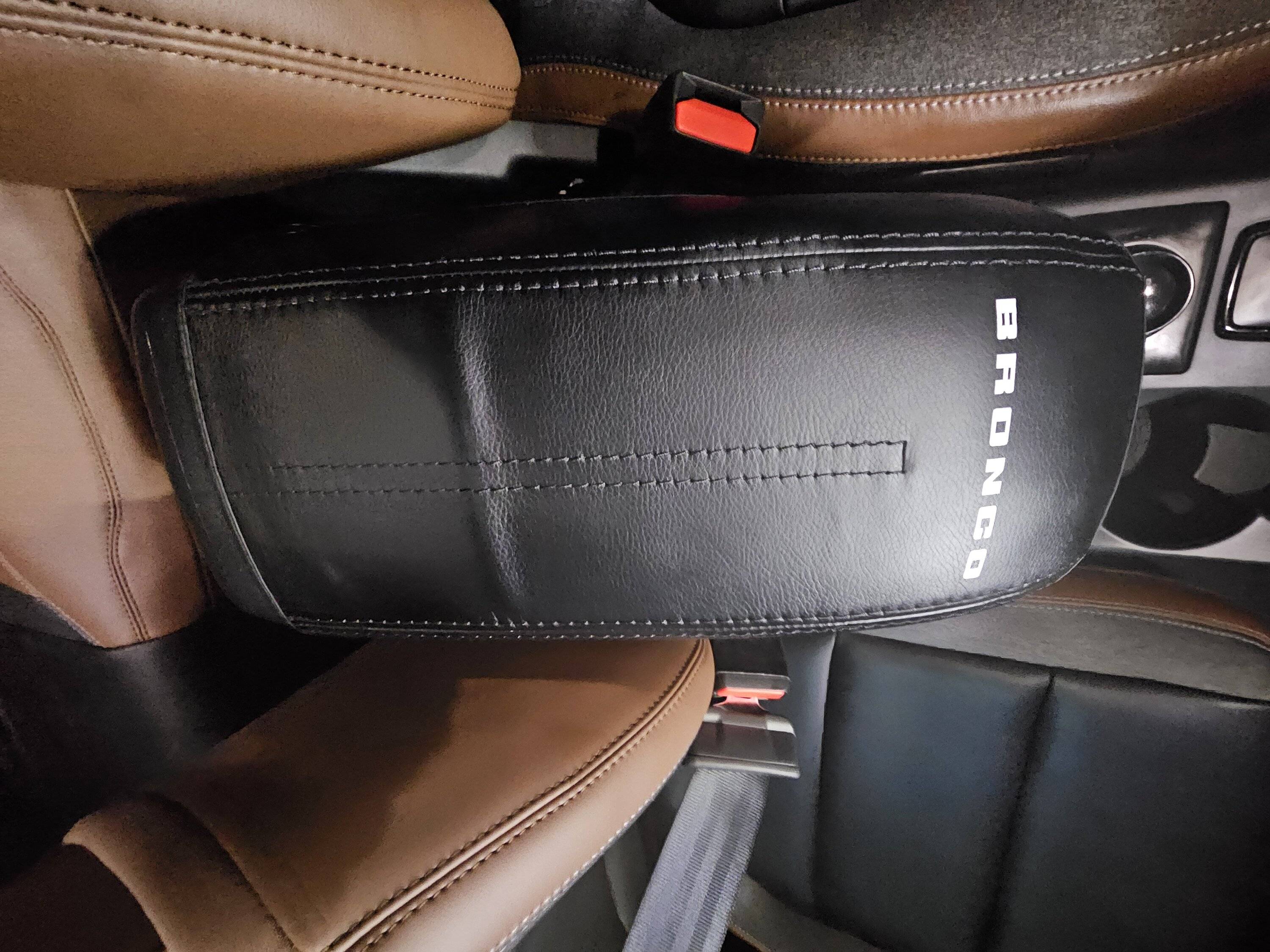 Ford Bronco Sport Anyone know of a center console armrest cover, preferably with bronco logo or Ford blue oval? 20240215_170731