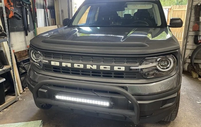 Installed Thule HD Cross Bars, Rough Country nudge Bull Bar, 20” LED Light Bar, Painted Letters